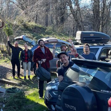 group of people gathered by their cars