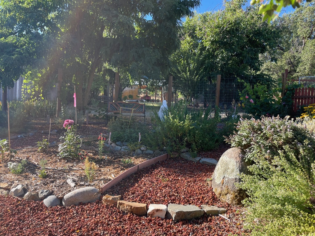 The herb garden finished with path going by rock, honoring loved ones